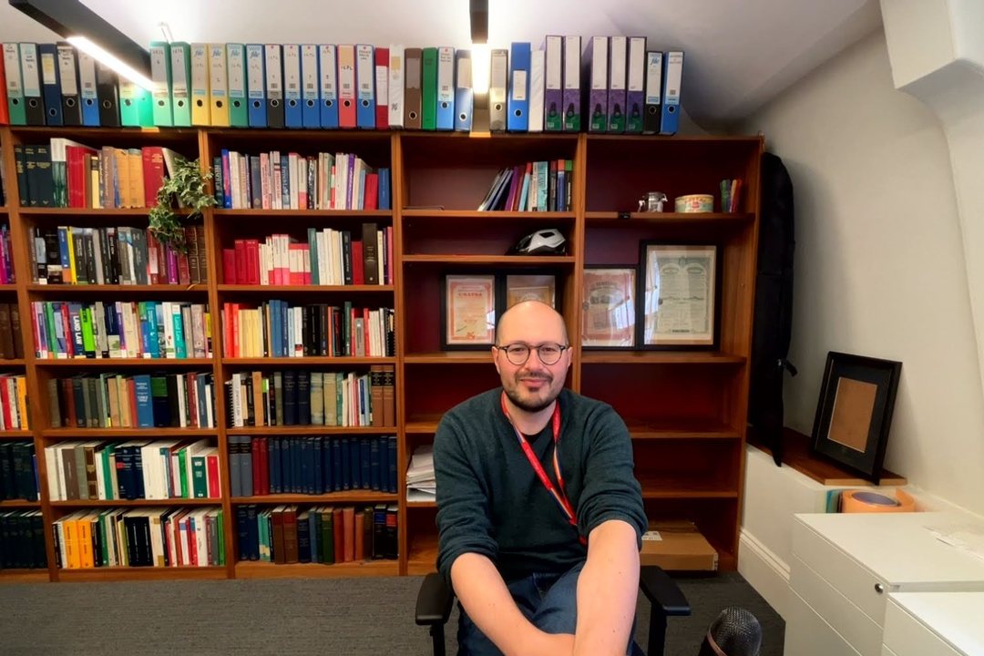 Niccolò Ridi in his office at King’s College London, in front of a wall of law books